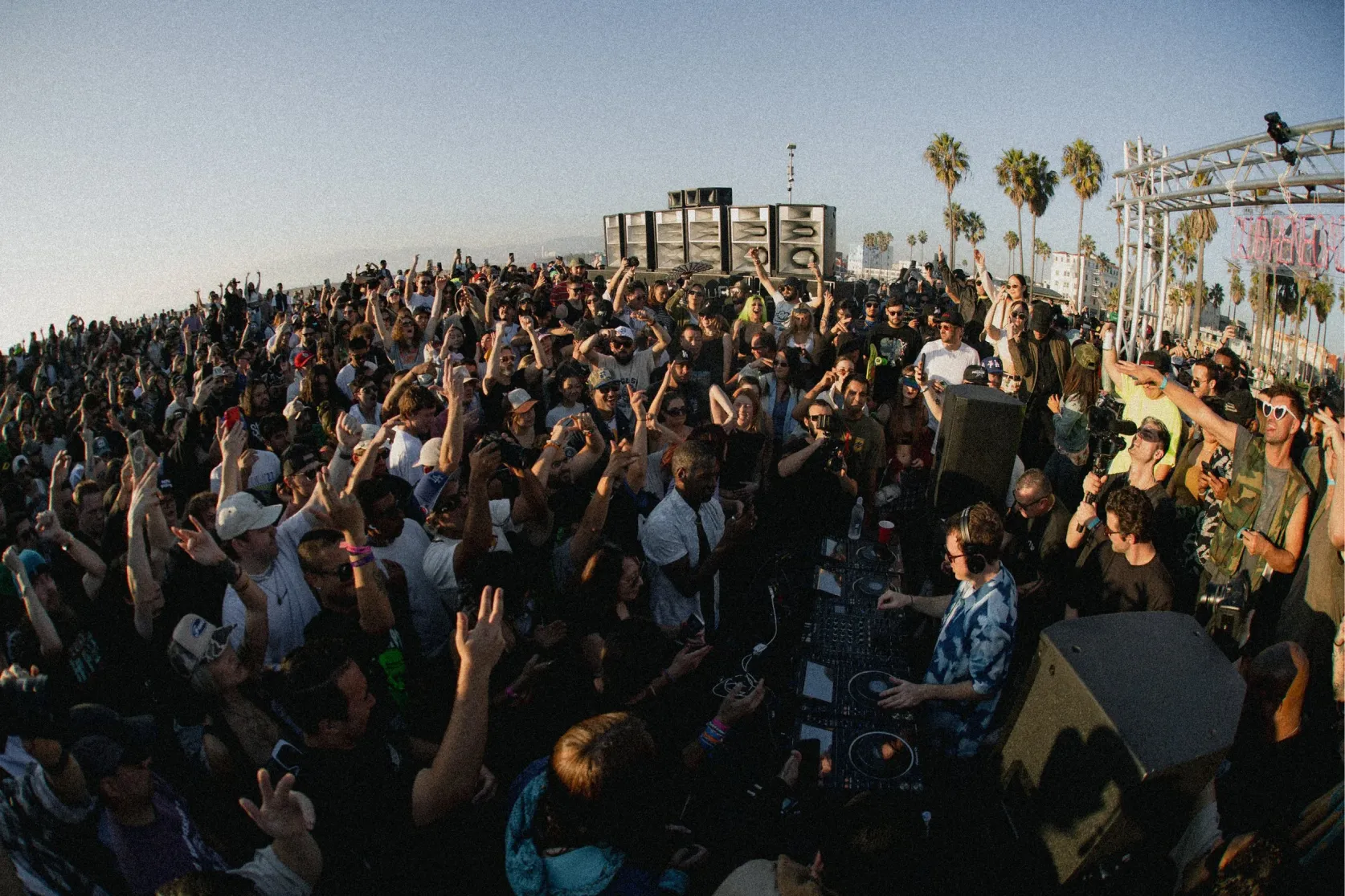 A crowd dancing at dusk